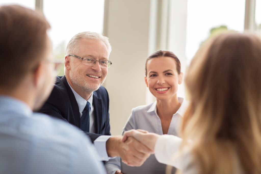 senior businessman making handshake at office